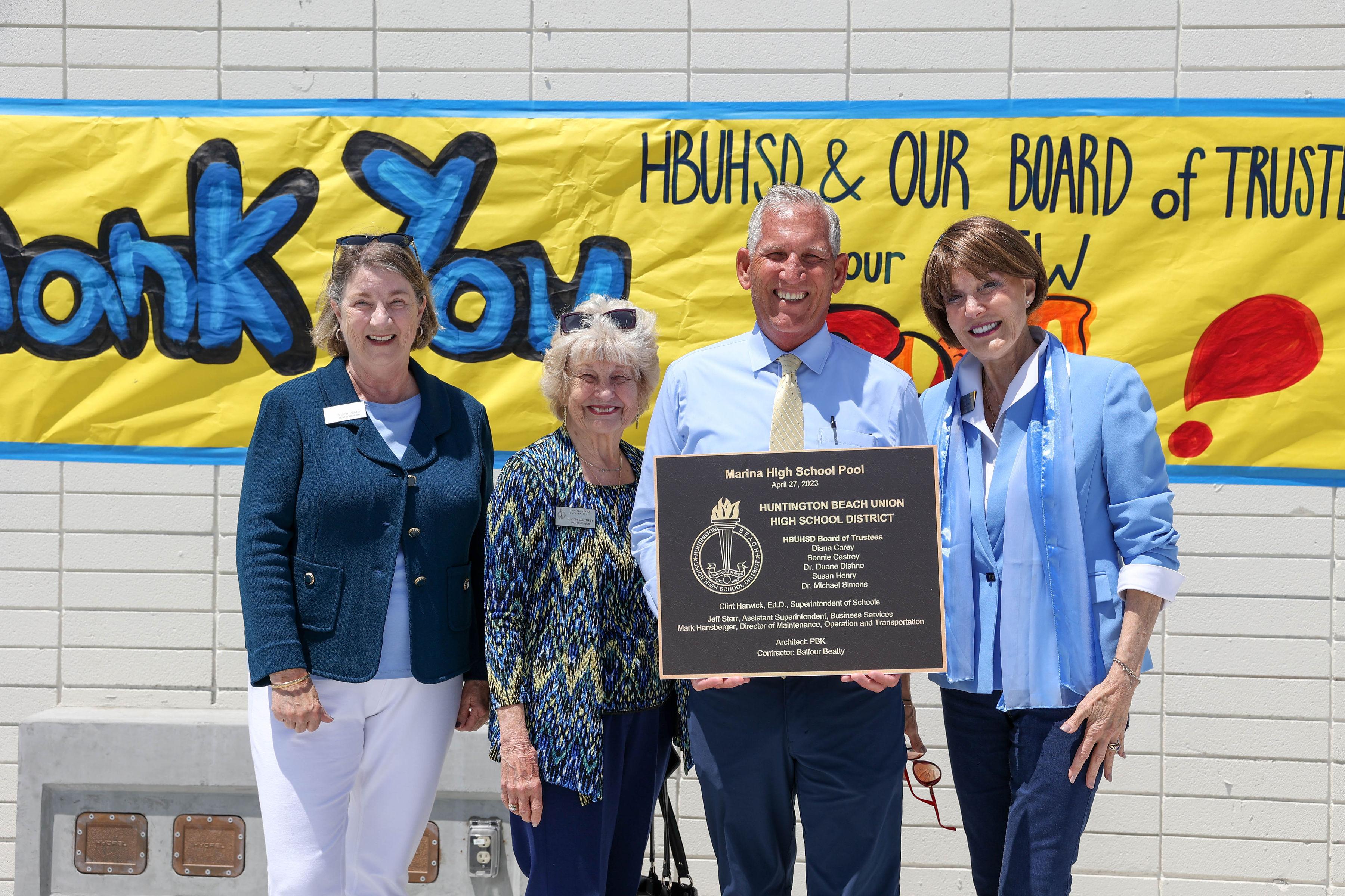 Dr. Harwick and board members presenting MHS pool plaque